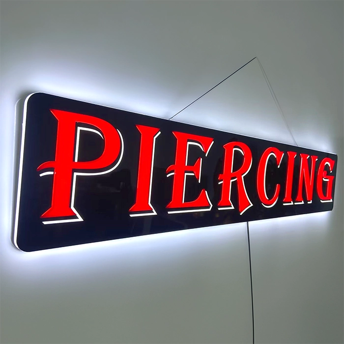Piercing LED Retail ready sign against a white wall lit at an angle