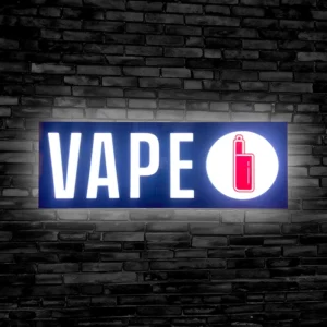 Lit up Vape LED sign mounted on a black brick wall