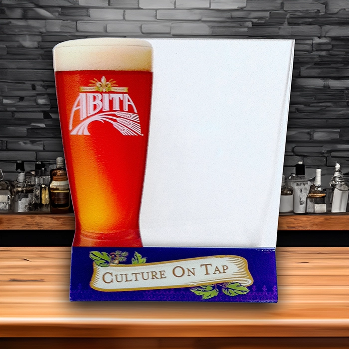 Abita Beer Brewery Acrylic Table menu that says Culture on Tap on a wood bar top with brick background