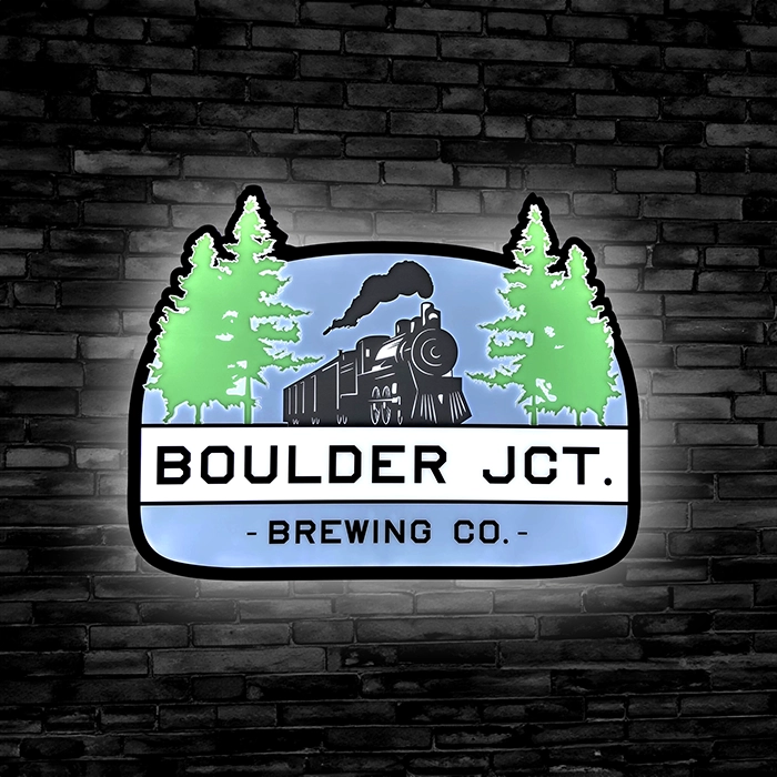 Boulder Jct. Brewery LED bar sign against a black brick wall