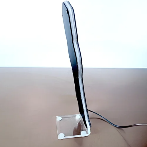 A desk lamp illuminating a table.