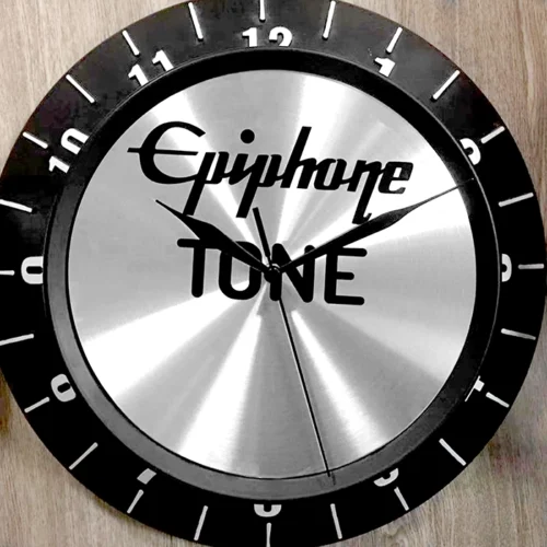 A clock with the word egypt tone on it, a non illuminated sign.