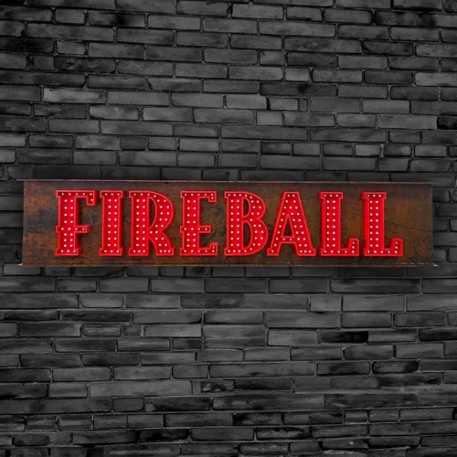 A non-illuminated fireball sign on a brick wall.