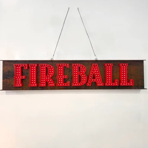 A high quality non-illuminated sign that says fireball hanging on a wall.