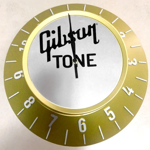 A clock with a gold dial, high quality non-illuminated signs. Gibson Tone