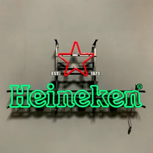 A LED neon sign of Heineken hanging on a wall.