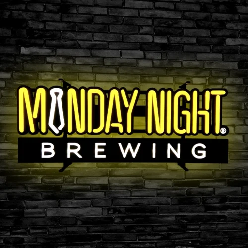 A LED neon sign on a brick wall.