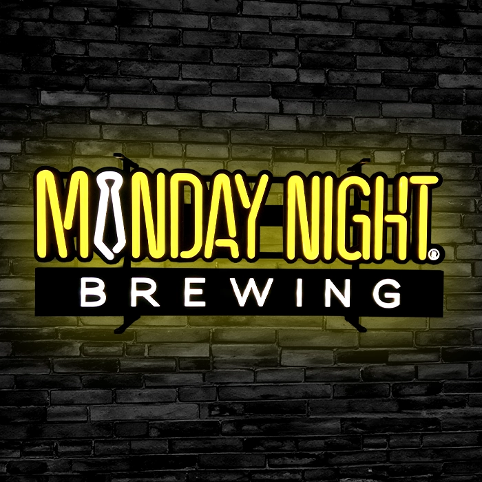 A LED neon sign on a brick wall.