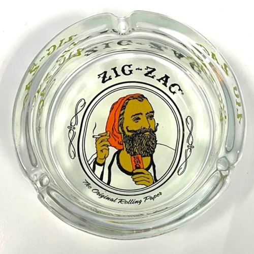 A glass ashtray with the image of a bearded man, perfect for Zig Zag