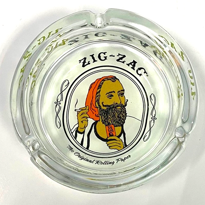 A glass ashtray with the image of a bearded man, perfect for Zig Zag