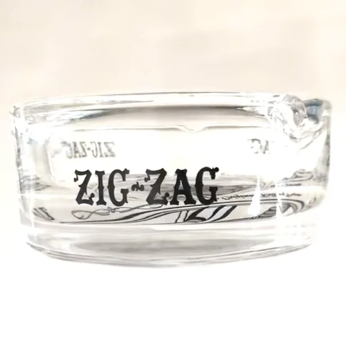 A glass ashtray with the Zig Zag logo.