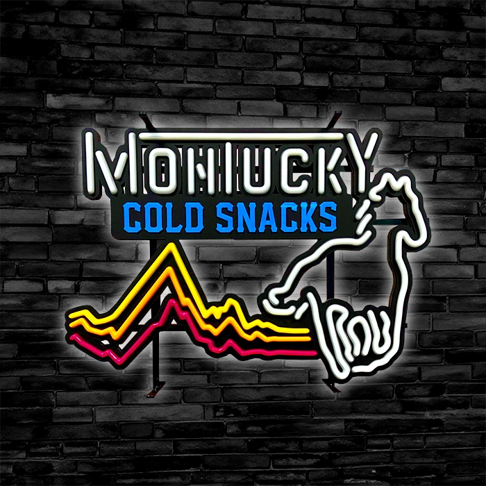 Custom LED neon sign on a brick wall reading "montucky cold snacks" with a stylized graphic of a hand holding a mountain range.