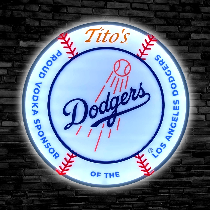 Round acrylic LED sign featuring the Los Angeles Dodgers logo and the text "Tito's Vodka sponsor of the Dodgers" on a brick wall background.
