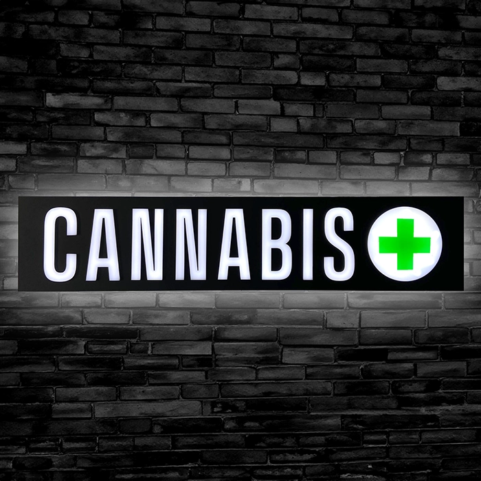 40" Cannabis LED Neon Sign with glowing Green Cross on Black Background.