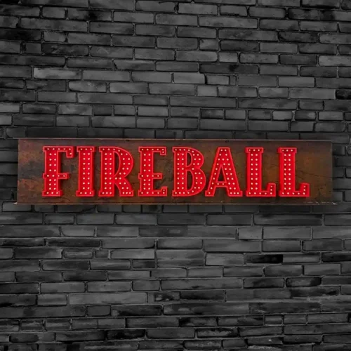 A non-illuminated fireball sign on a brick wall.
